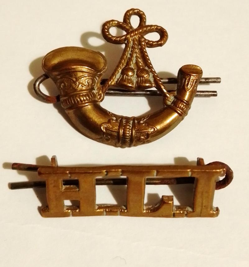 Highland Light Infantry brass badges